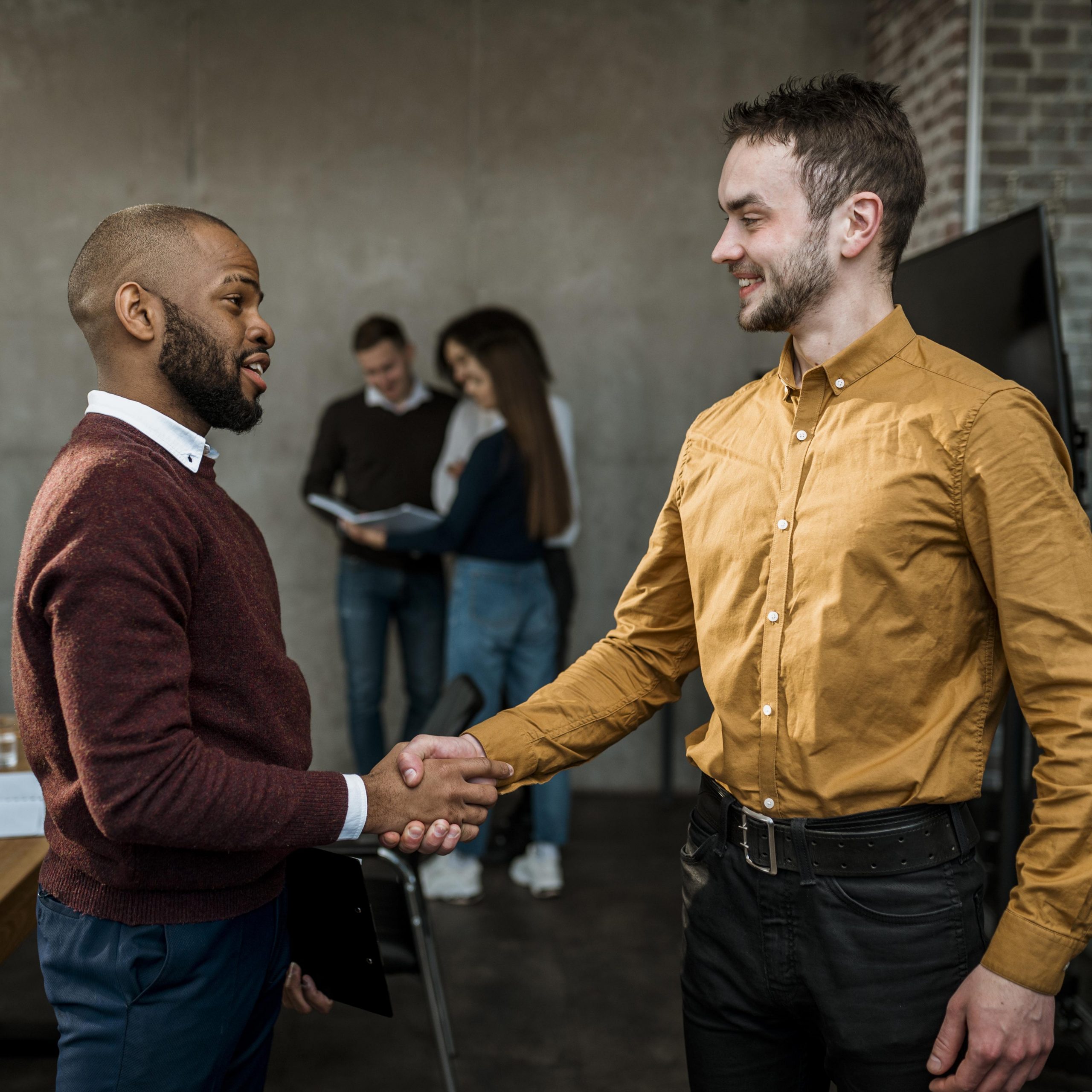 side-view-of-men-handshaking-in-agreement-after-a-meeting