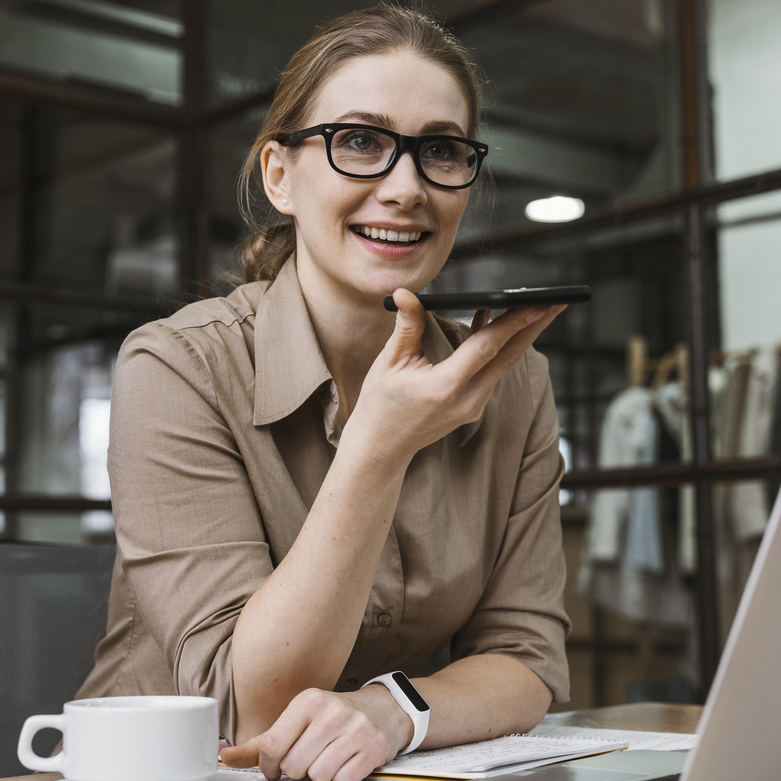 young-businesswoman-talking-on-the-phone-during-a-meeting